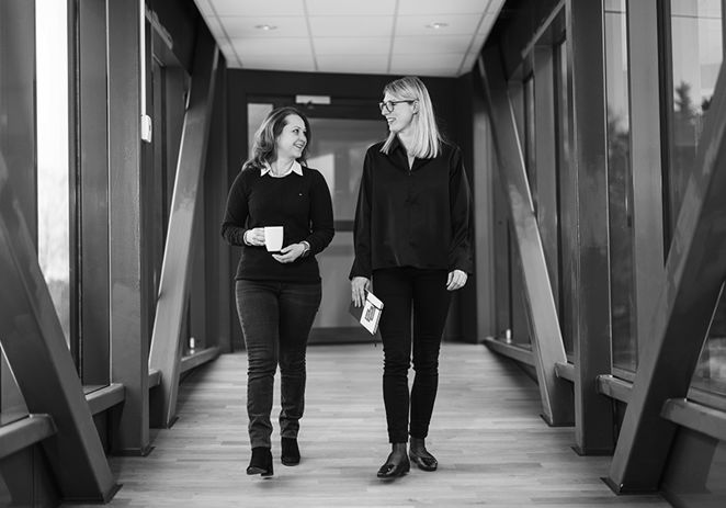 Två personer som går i en kontorskorridor